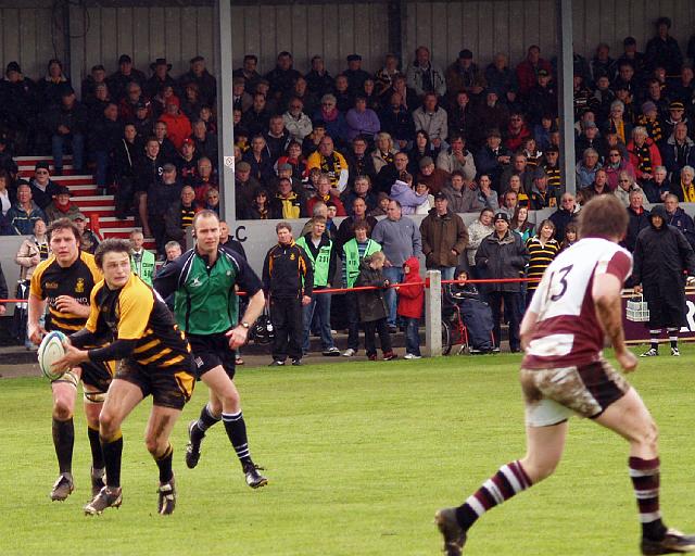 A packed stand watch Lewis Webb spread the ball wide.jpg - A packed stand watches fly-half Lewis Webb spread the ball wide. Photo by John Beach.